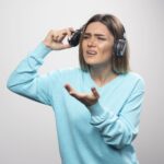can you wear headphones with hearing aids?